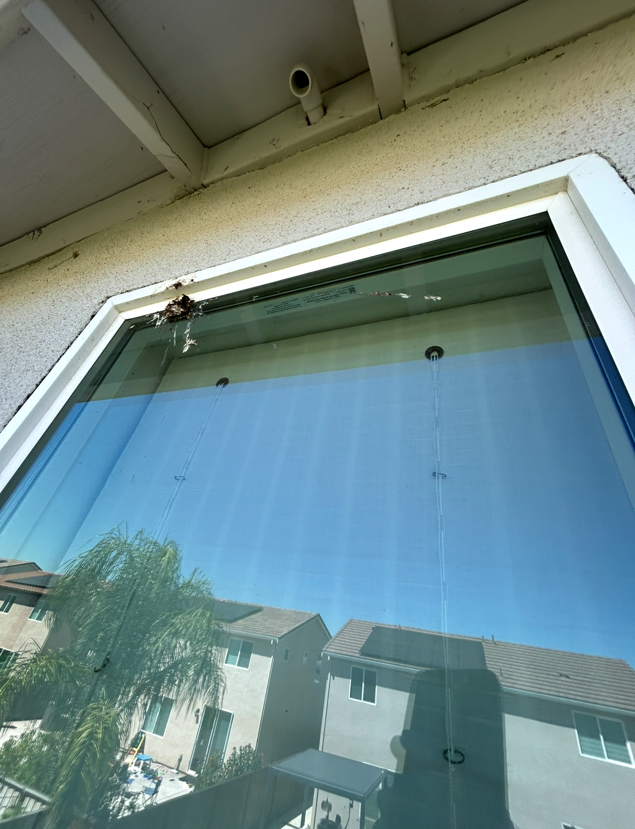 Upstairs glass with hard-water spotting before cleaning