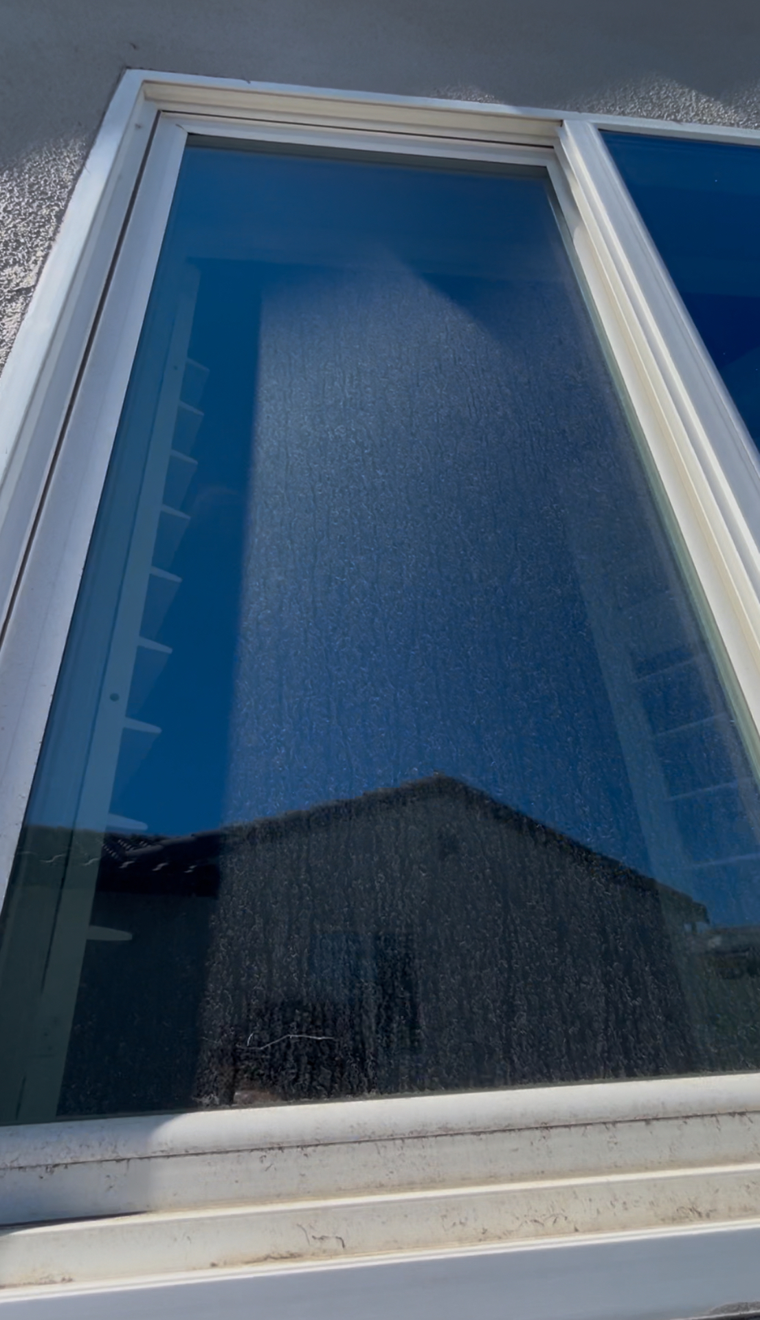 Second-story picture window before cleaning